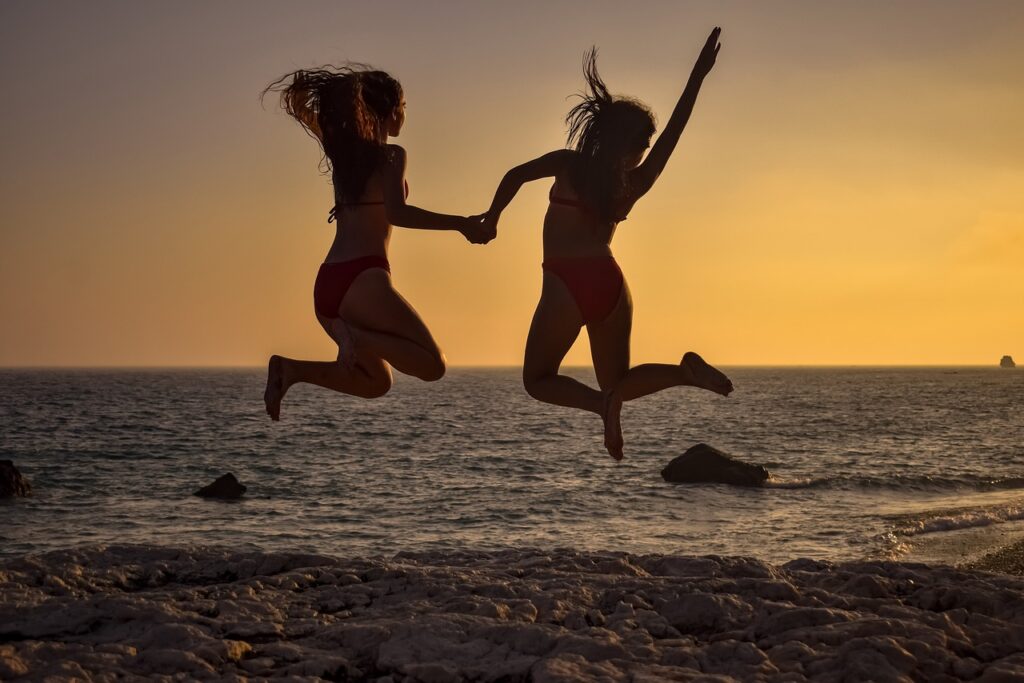 girls, jumping, beach-5895385.jpg